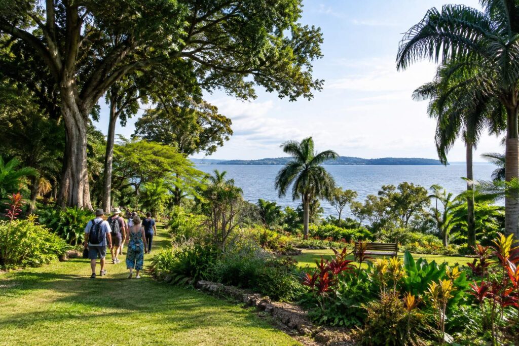 Travellers walking through Entebbe Botanical Gardens with a scenic Lake Victoria view in Uganda